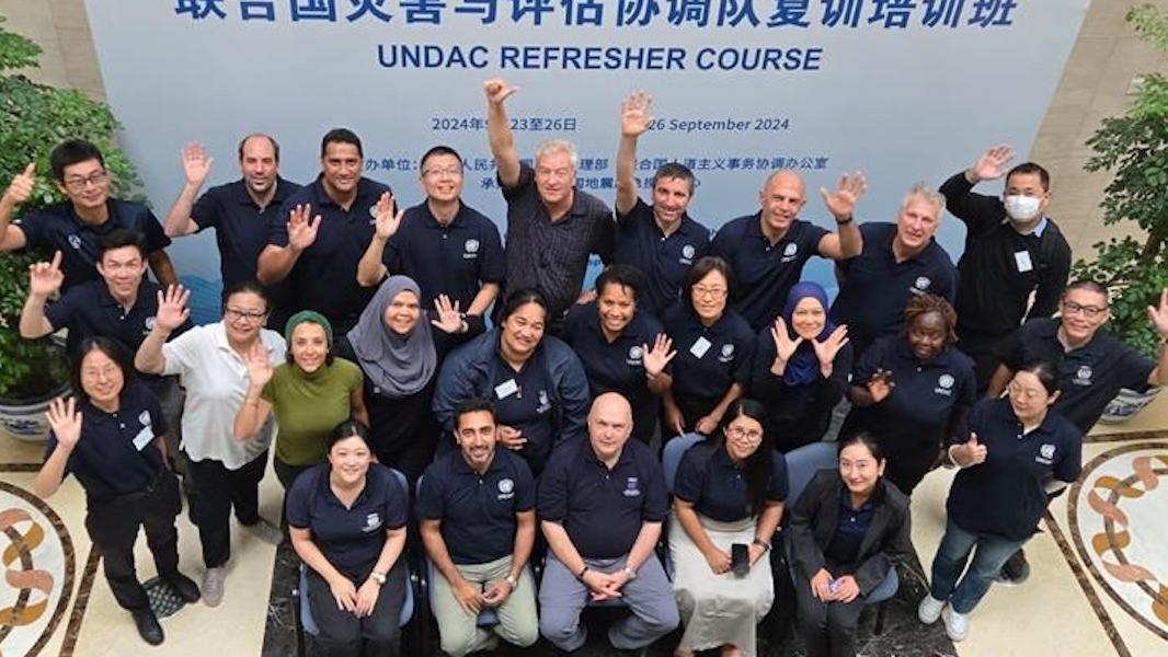 UNDAC China refresher participants looking up to the camera as a group