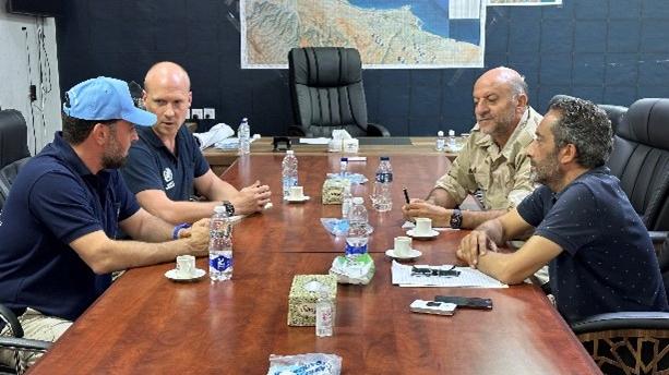 Meshari, with the blue hat, at UNDAC meeting with Derna Security chief, 2023. 