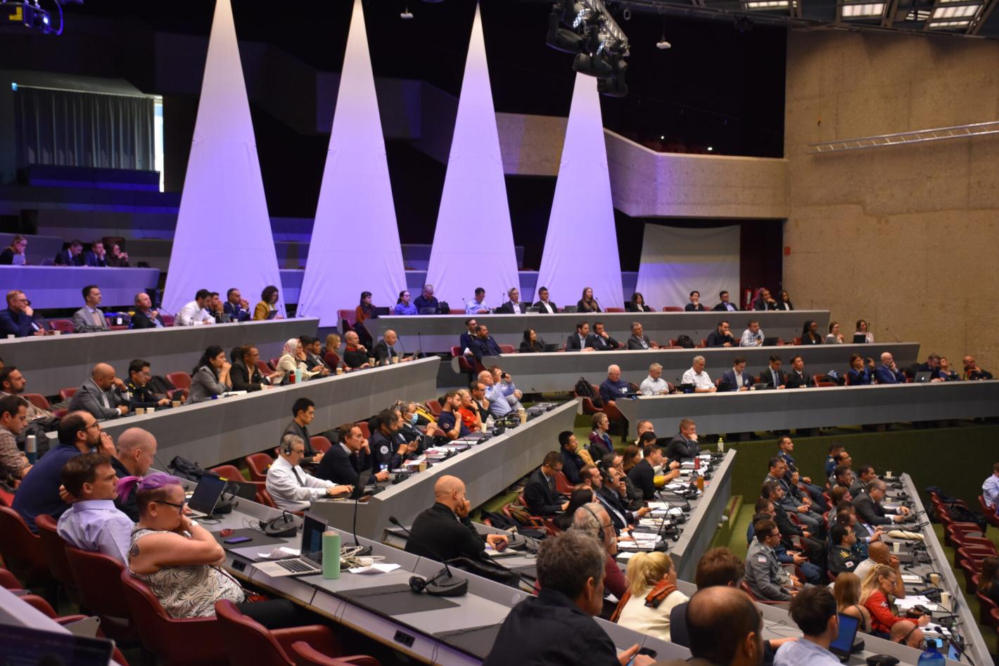 Conference room of people at the Humanitarian Network Partnership Week - listening to UNDAC Advistory board