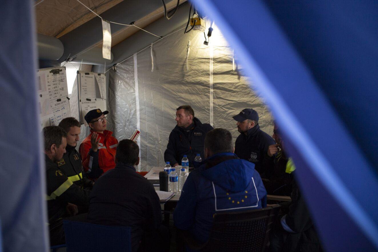 UNDAC running a coordination meeting in a tent